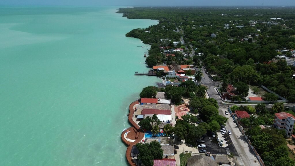 Aerial view of Bacalar Lagoon's turquoise waters and the town in Quintana Roo, Mexico.