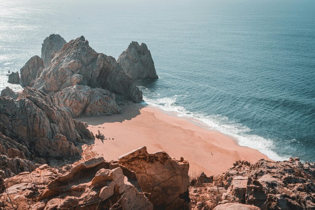 Serene Cabo San Lucas beach view with rocky formations and a tranquil ocean scene.