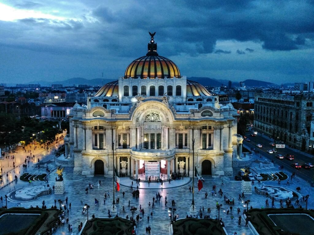 Stunning aerial view of Palacio de Bellas Artes with cityscape at dusk. A prime travel destination and cultural landmark.