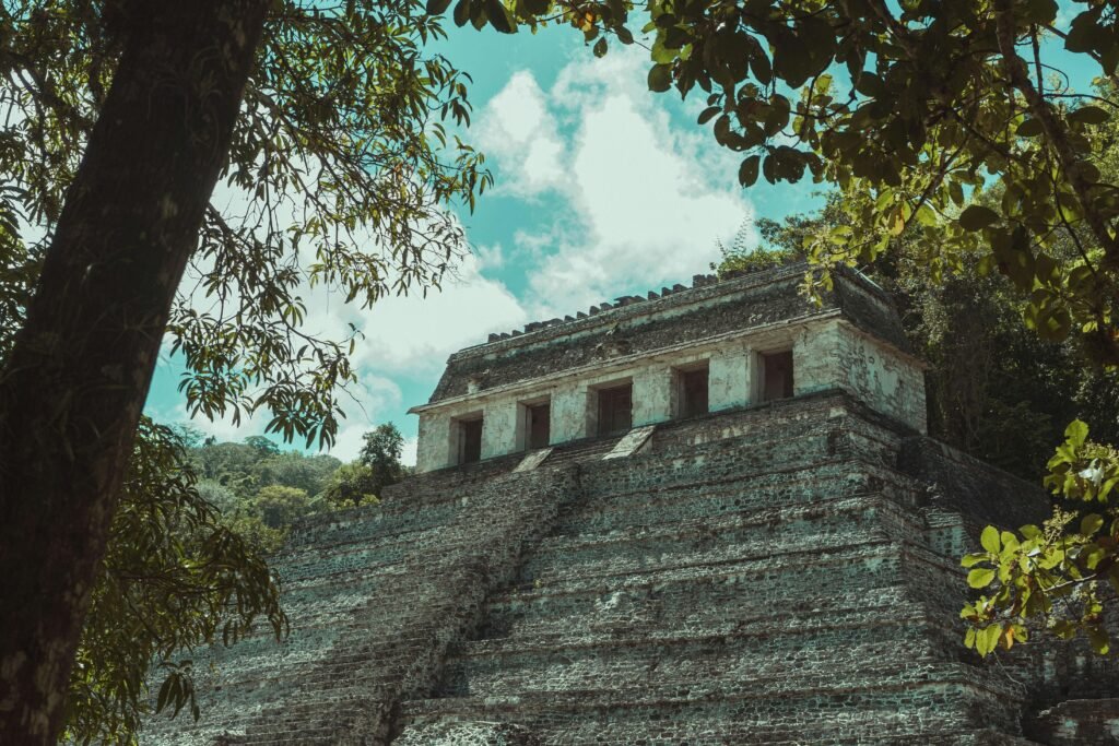 Explore the majestic ancient Mayan ruins surrounded by a dense Mexican jungle, showcasing historical architecture and natural beauty.